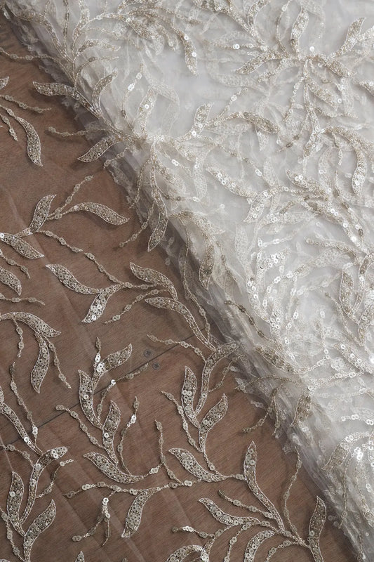 AIzaSyBcstauz-XMPRhEY21AUzeo032pxrXB5Ug - Gold And Silver Sequins Leafy Floral Embroidery On Dyeable White Soft Net Fabric