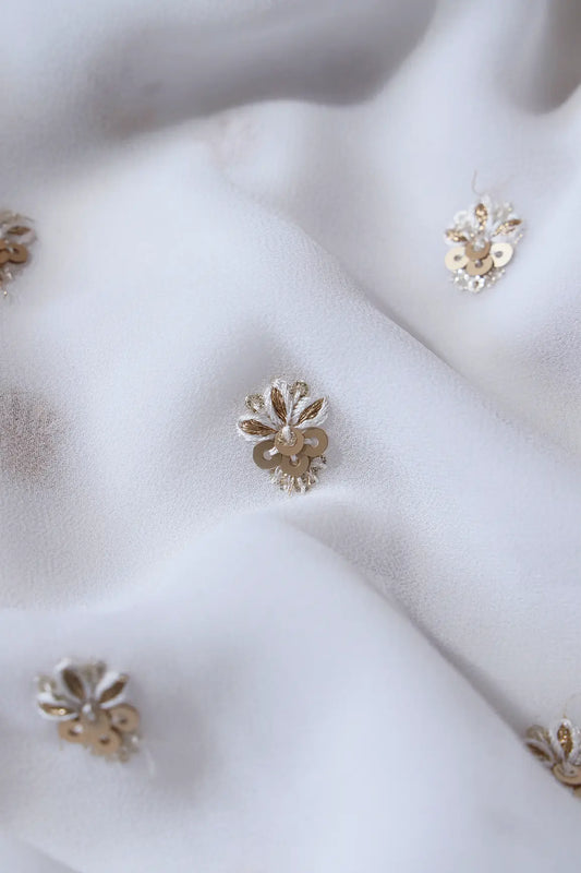 AIzaSyBcstauz-XMPRhEY21AUzeo032pxrXB5Ug - Gold Sequins With Zari Small Floral Booti Embroidery On White Georgette Fabric