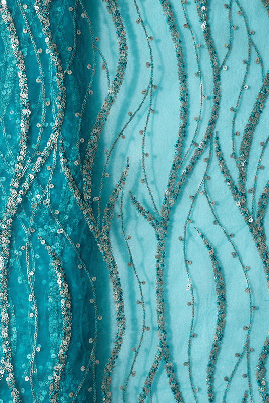 AIzaSyBcstauz-XMPRhEY21AUzeo032pxrXB5Ug - Gold And Silver Sequins With Peacock Blue Thread Wavy Embroidery On Peacock Blue Soft Net Fabric