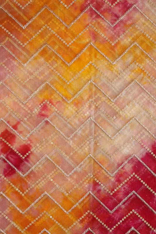 AIzaSyBcstauz-XMPRhEY21AUzeo032pxrXB5Ug - Gold Zari With Gold Sequins Chevron Embroidery Work On Tie & Dye Dark Pink And Yellow Organza Fabric