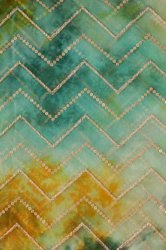 AIzaSyBcstauz-XMPRhEY21AUzeo032pxrXB5Ug - Gold Zari With Gold Sequins Chevron Embroidery Work On Tie & Dye Teal And Green Organza Fabric