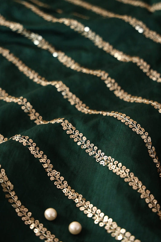 AIzaSyBcstauz-XMPRhEY21AUzeo032pxrXB5Ug - Gold Sequins With Gold Zari Stripes Embroidery Work On Bottle Green Raw Silk Fabric