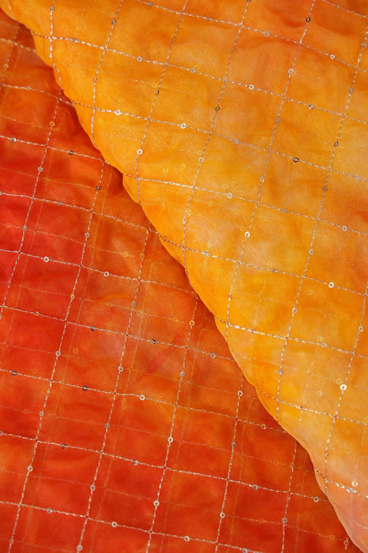 AIzaSyBcstauz-XMPRhEY21AUzeo032pxrXB5Ug - Gold Zari With Gold Sequins Checks Embroidery Work On Tie & Dye Orange And Yellow Organza Fabric