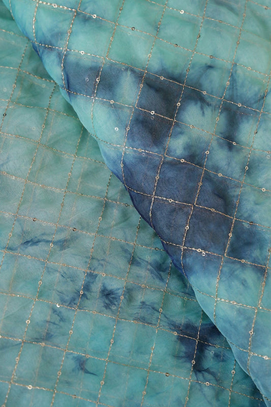 AIzaSyBcstauz-XMPRhEY21AUzeo032pxrXB5Ug - Gold Zari With Gold Sequins Checks Embroidery Work On Tie & Dye Turquoise And Blue Organza Fabric