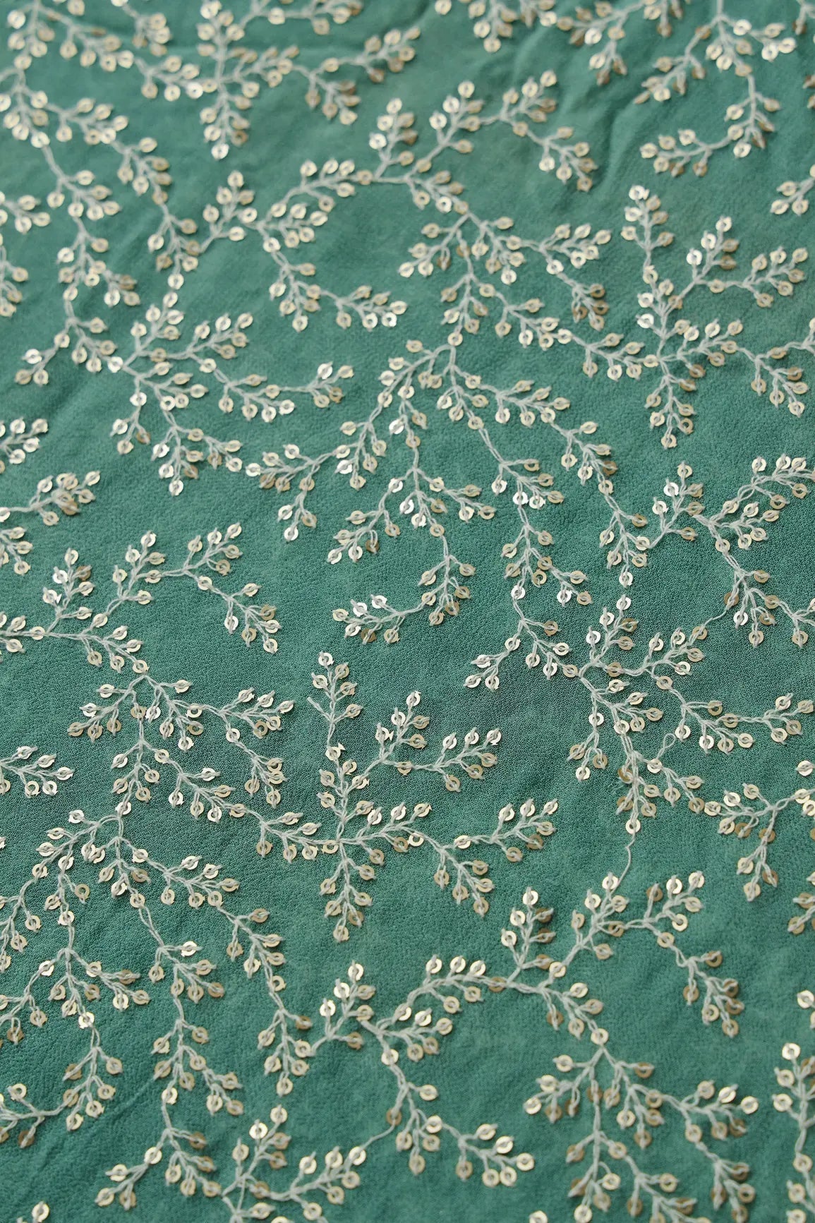 AIzaSyBcstauz-XMPRhEY21AUzeo032pxrXB5Ug - 3.25 Meter Cut Piece Of White Thread With Gold Sequins Leafy Embroidery On Teal Georgette Fabric