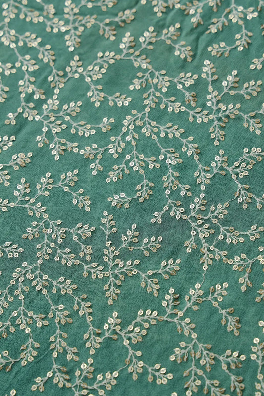 AIzaSyBcstauz-XMPRhEY21AUzeo032pxrXB5Ug - 3.25 Meter Cut Piece Of White Thread With Gold Sequins Leafy Embroidery On Teal Georgette Fabric