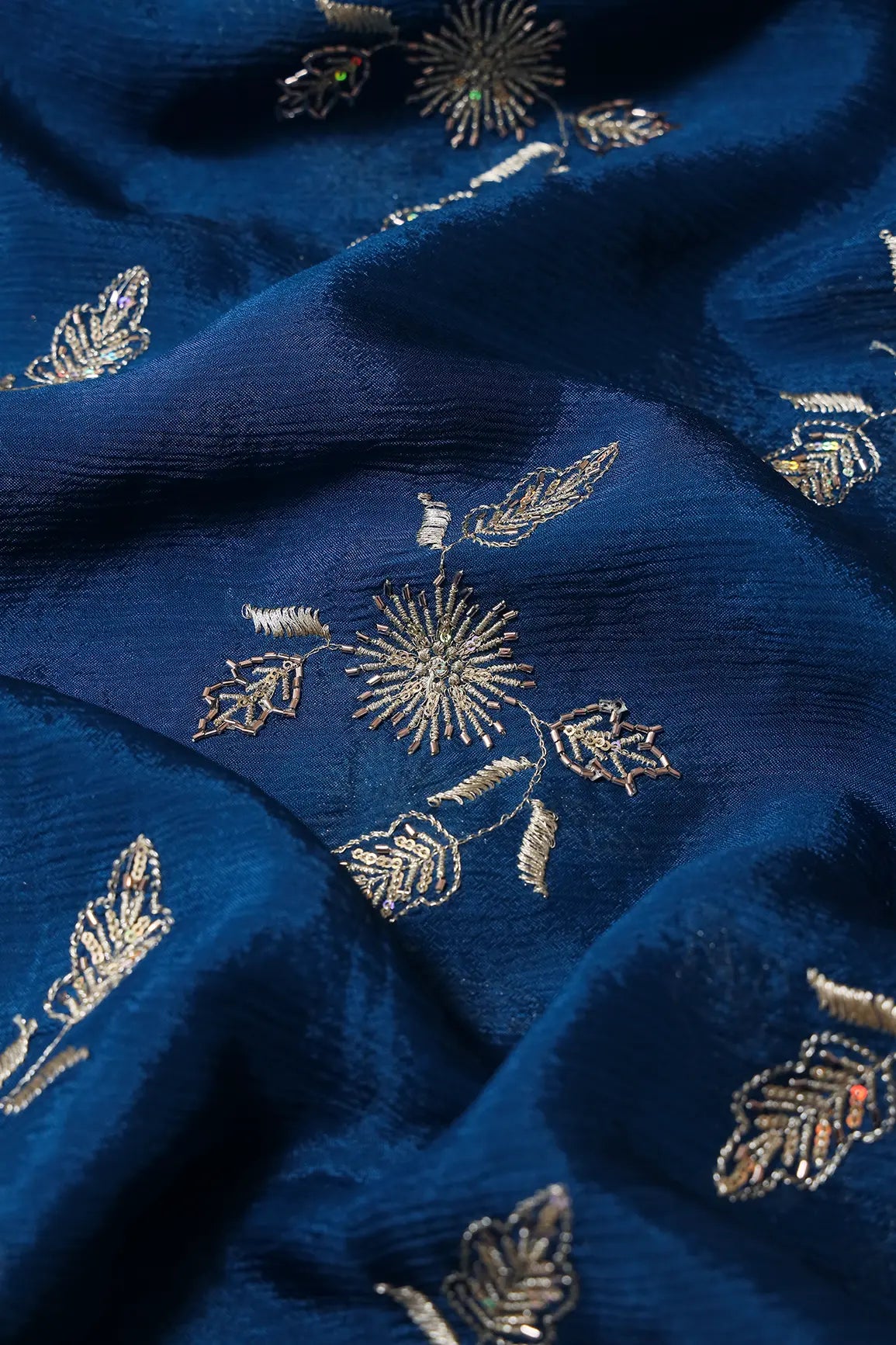 AIzaSyBcstauz-XMPRhEY21AUzeo032pxrXB5Ug - Gold Sequins With Beads And Gold Zari Floral Butta Embroidery On Prussian Blue Chinnon Chiffon Fabric