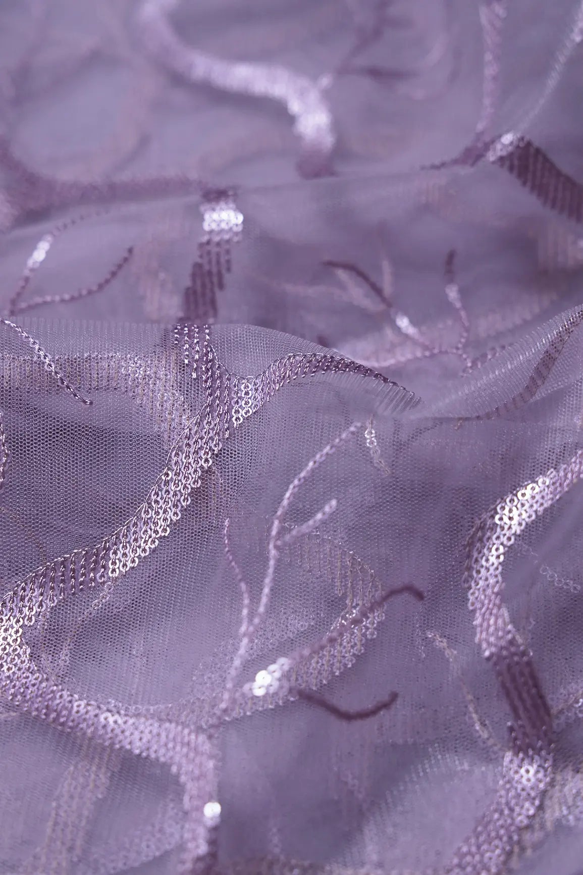 AIzaSyBcstauz-XMPRhEY21AUzeo032pxrXB5Ug - Light Lilac Sequins Abstract Embroidery On Lilac Soft Net Fabric