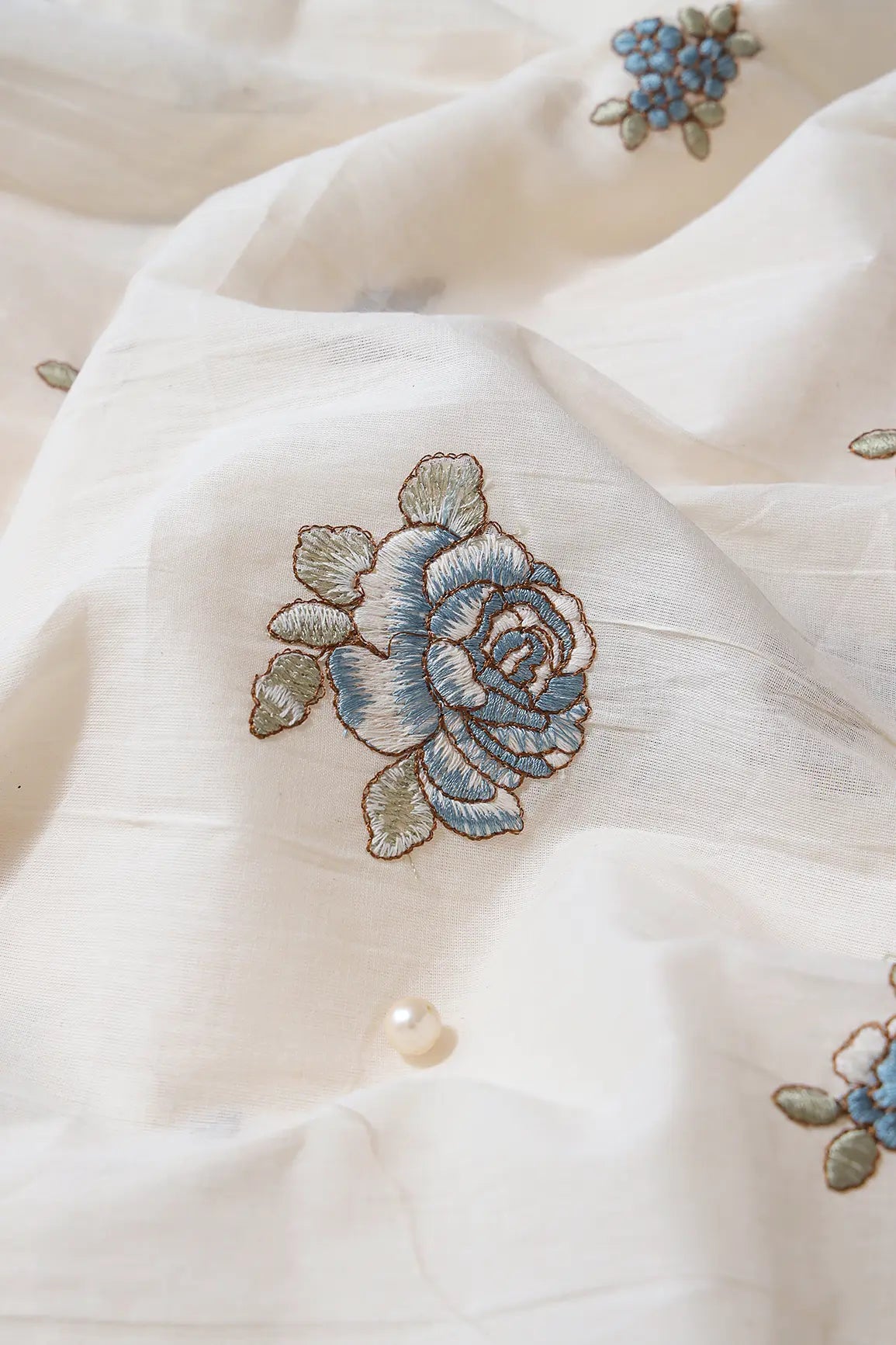 AIzaSyBcstauz-XMPRhEY21AUzeo032pxrXB5Ug - Blue And Olive Thread Floral Embroidery On Off White Organic Cotton Fabric