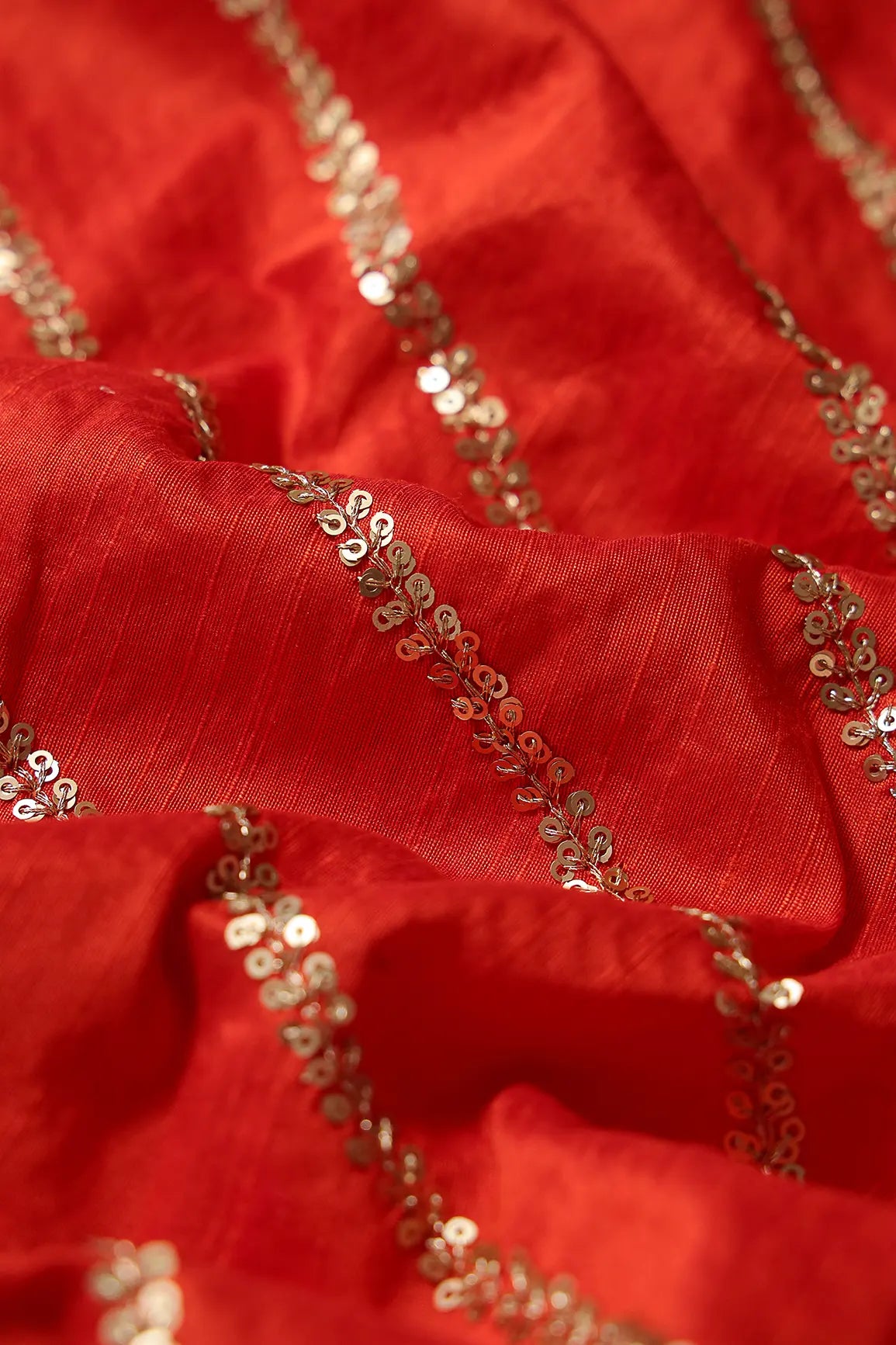 AIzaSyBcstauz-XMPRhEY21AUzeo032pxrXB5Ug - Gold Sequins With Gold Zari Stripes Embroidery Work On Dark Orange Raw Silk Fabric