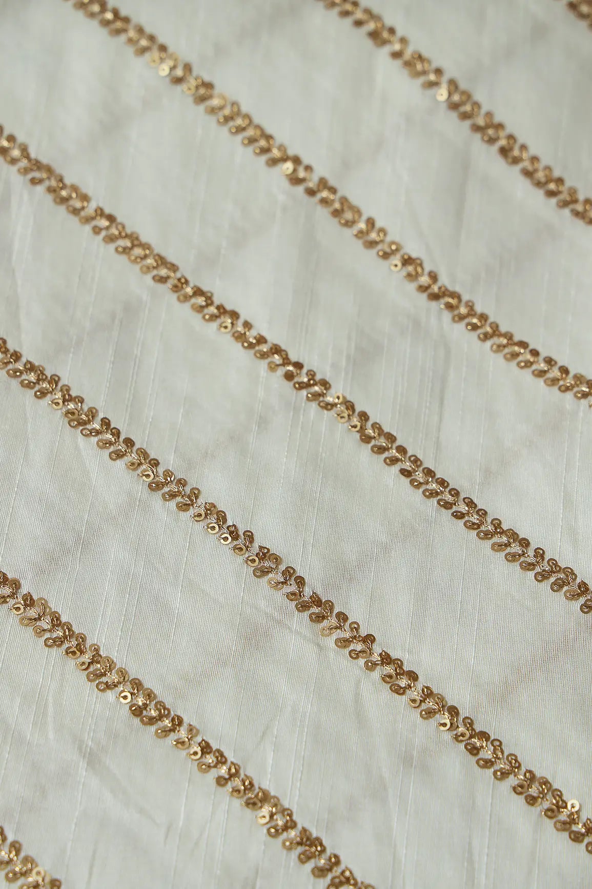 AIzaSyBcstauz-XMPRhEY21AUzeo032pxrXB5Ug - Gold Sequins With Gold Zari Stripes Embroidery Work On White Raw Silk Fabric