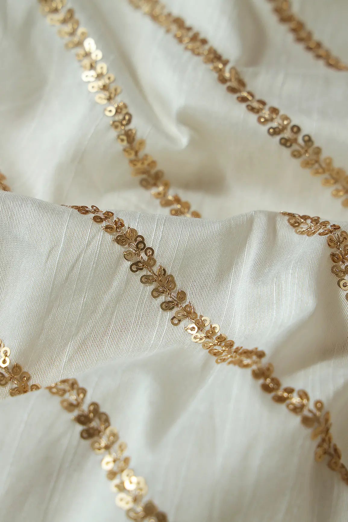AIzaSyBcstauz-XMPRhEY21AUzeo032pxrXB5Ug - Gold Sequins With Gold Zari Stripes Embroidery Work On White Raw Silk Fabric