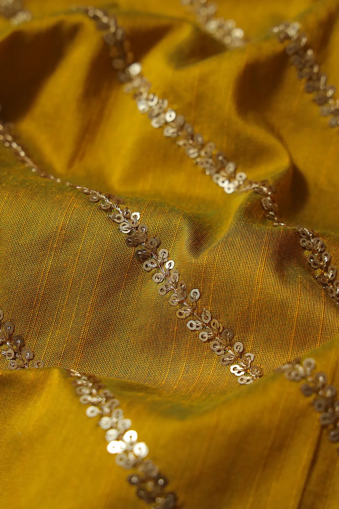 AIzaSyBcstauz-XMPRhEY21AUzeo032pxrXB5Ug - Gold Sequins With Gold Zari Stripes Embroidery Work On Dark Mustard Raw Silk Fabric