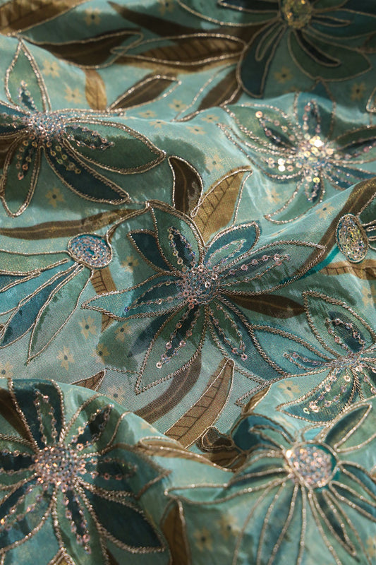 AIzaSyBcstauz-XMPRhEY21AUzeo032pxrXB5Ug - Floral Position Print On Sequins With Zari Embroidery On Pastel Olive Viscose Zari Tissue Fabric