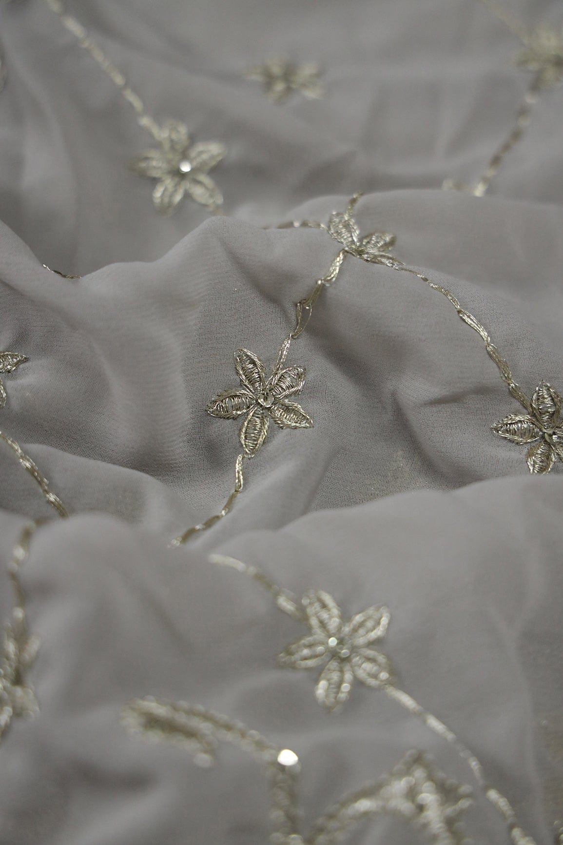 AIzaSyBcstauz-XMPRhEY21AUzeo032pxrXB5Ug - Big Width''56'' Gold And Silver Zari Floral Embroidery Work On Grey Georgette Fabric With Border