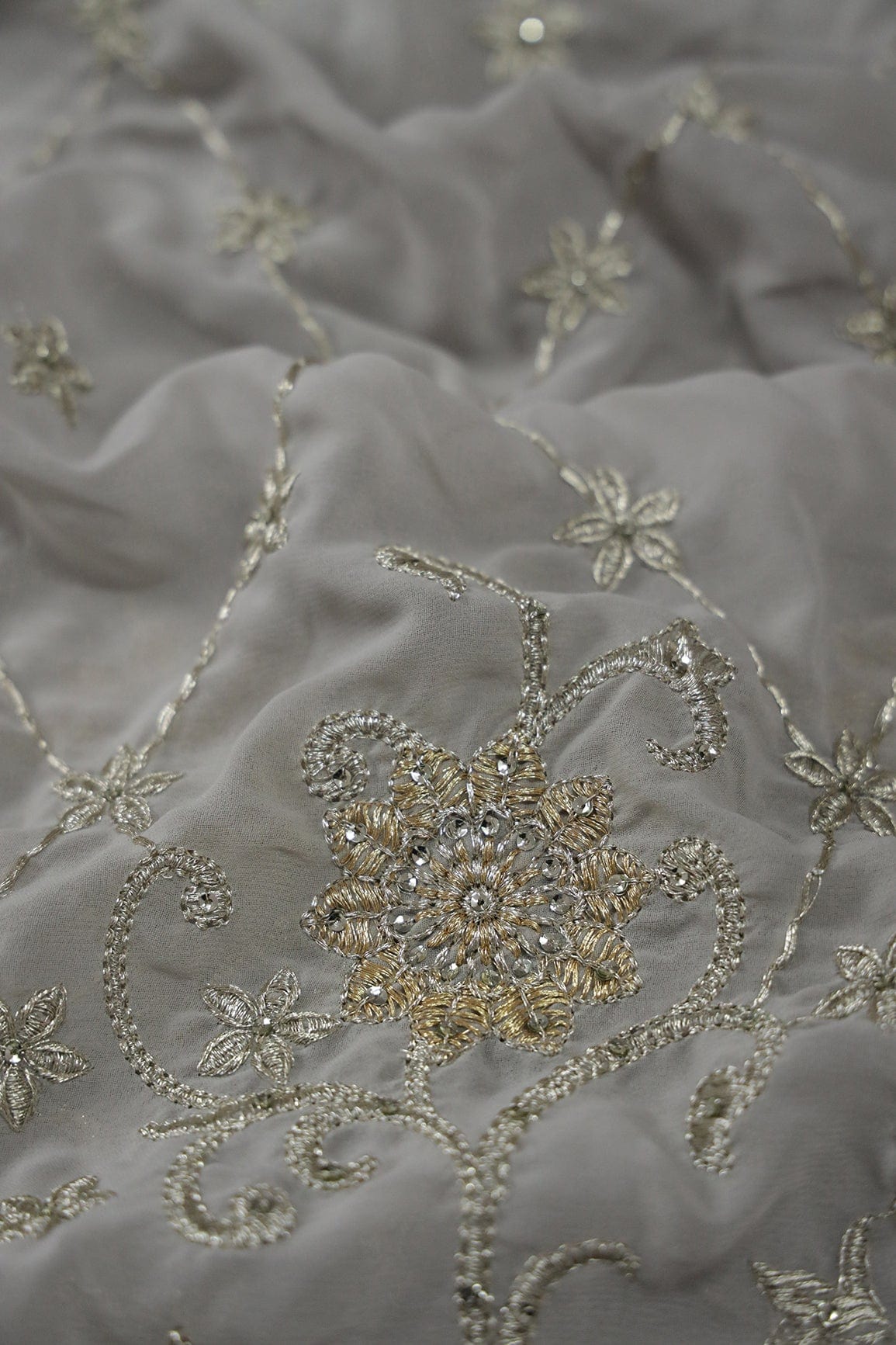 AIzaSyBcstauz-XMPRhEY21AUzeo032pxrXB5Ug - Big Width''56'' Gold And Silver Zari Floral Embroidery Work On Grey Georgette Fabric With Border