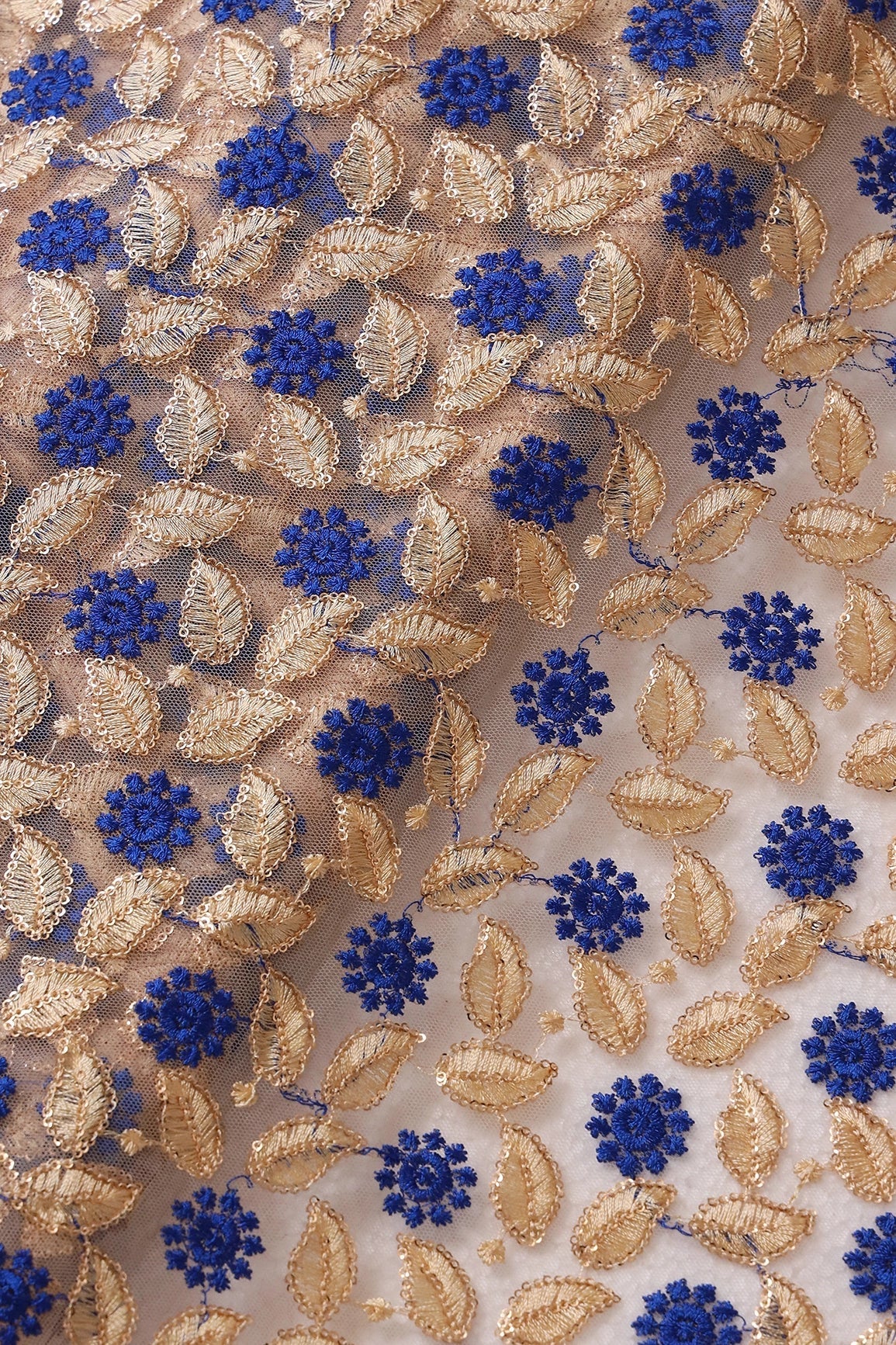 AIzaSyBcstauz-XMPRhEY21AUzeo032pxrXB5Ug - Blue And Beige Thread With Sequins Leafy Embroidery On Beige Soft Net Fabric