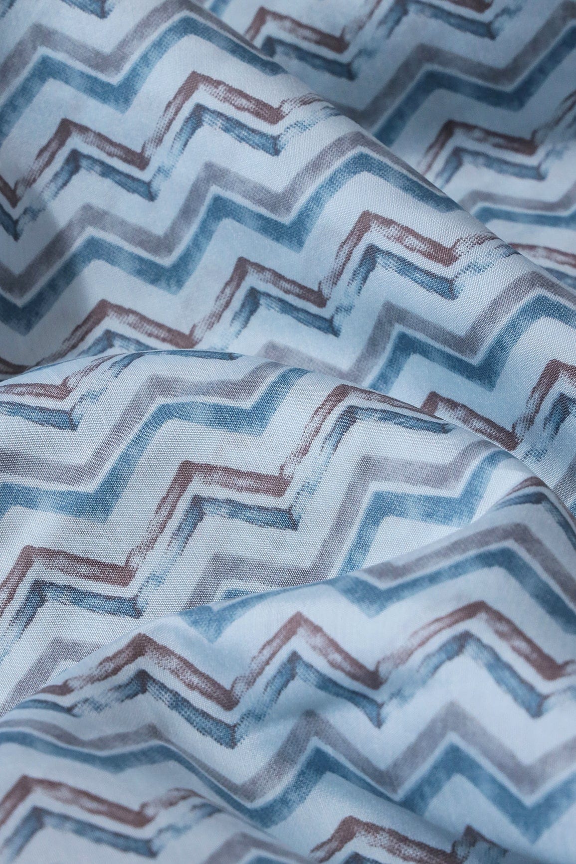 AIzaSyBcstauz-XMPRhEY21AUzeo032pxrXB5Ug - Blue And Brown Chevron Print On Pastel Blue Viscose Chanderi Silk Fabric