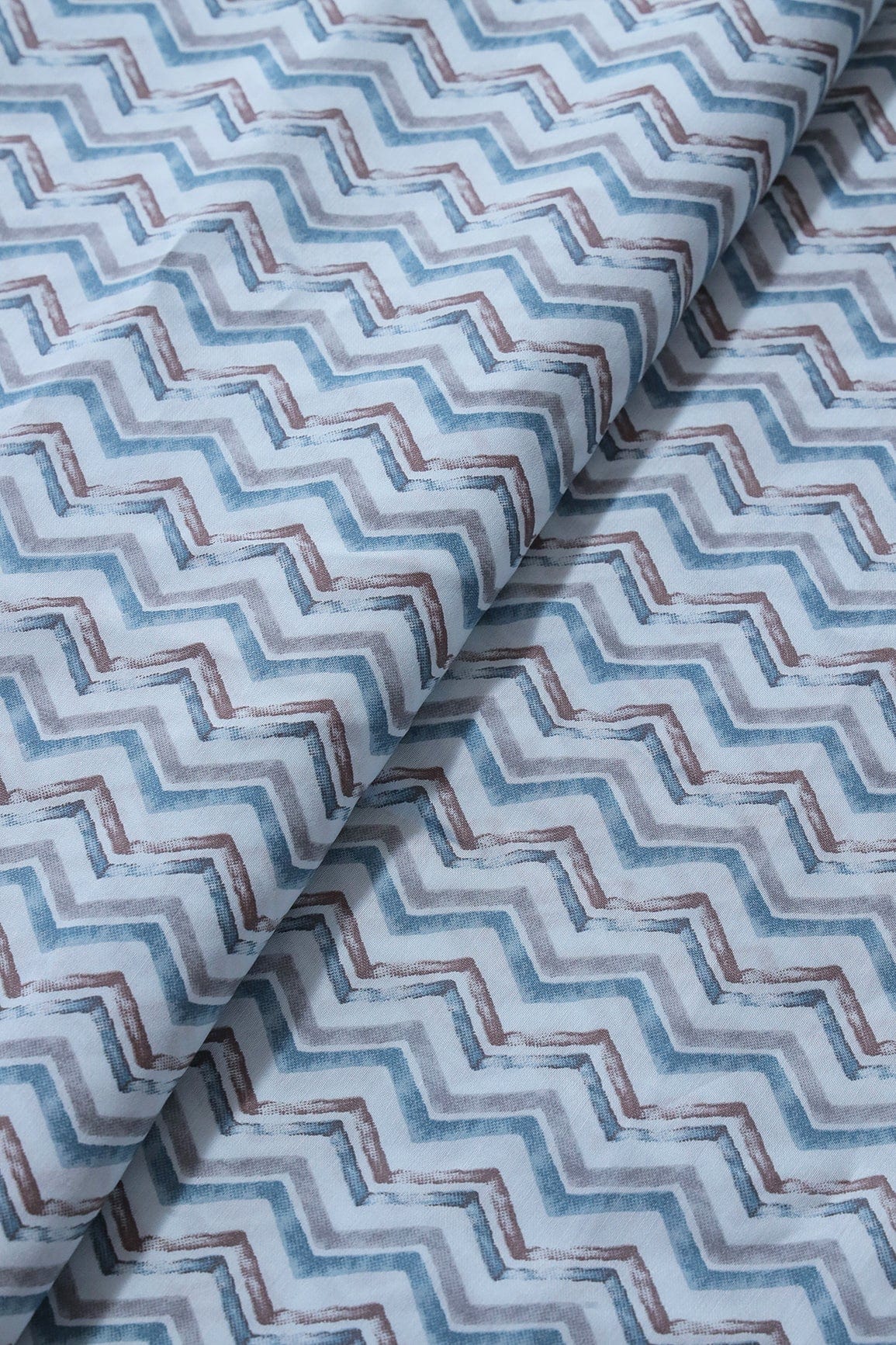 AIzaSyBcstauz-XMPRhEY21AUzeo032pxrXB5Ug - Blue And Brown Chevron Print On Pastel Blue Viscose Chanderi Silk Fabric