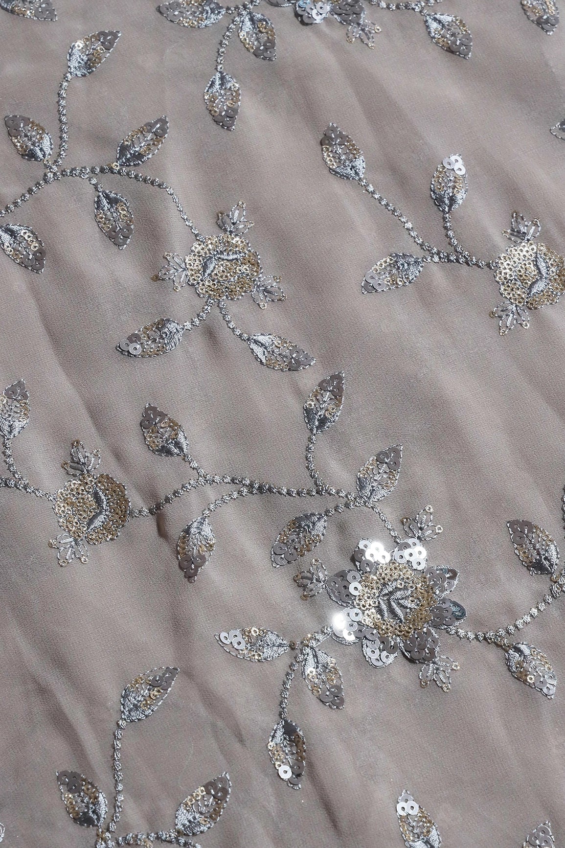 AIzaSyBcstauz-XMPRhEY21AUzeo032pxrXB5Ug - Gold And Silver Sequins Floral Embroidery Work On Grey Georgette Fabric