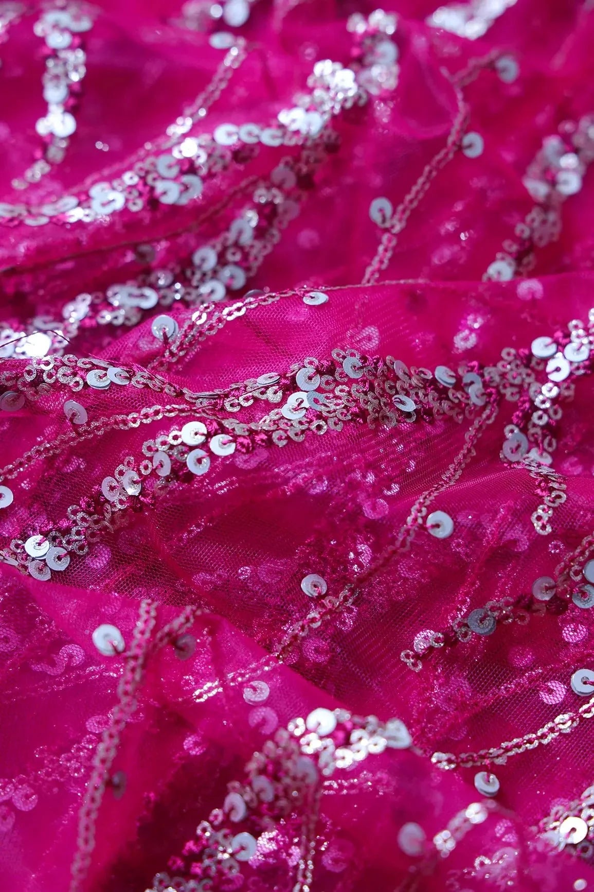 AIzaSyBcstauz-XMPRhEY21AUzeo032pxrXB5Ug - Gold And Silver Sequins With Fuchsia Thread Wavy Embroidery Work On Fuchsia Soft Net Fabric