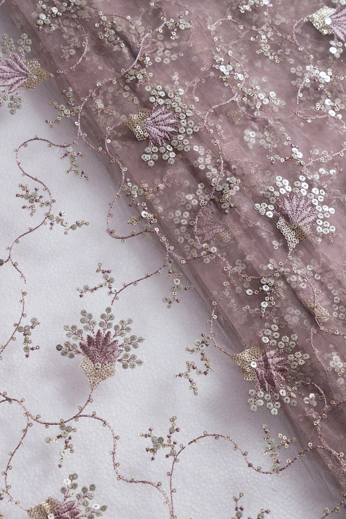 AIzaSyBcstauz-XMPRhEY21AUzeo032pxrXB5Ug - Gold And Silver Sequins With Mauve Thread Floral Embroidery Work On Mauve Soft Net Fabric