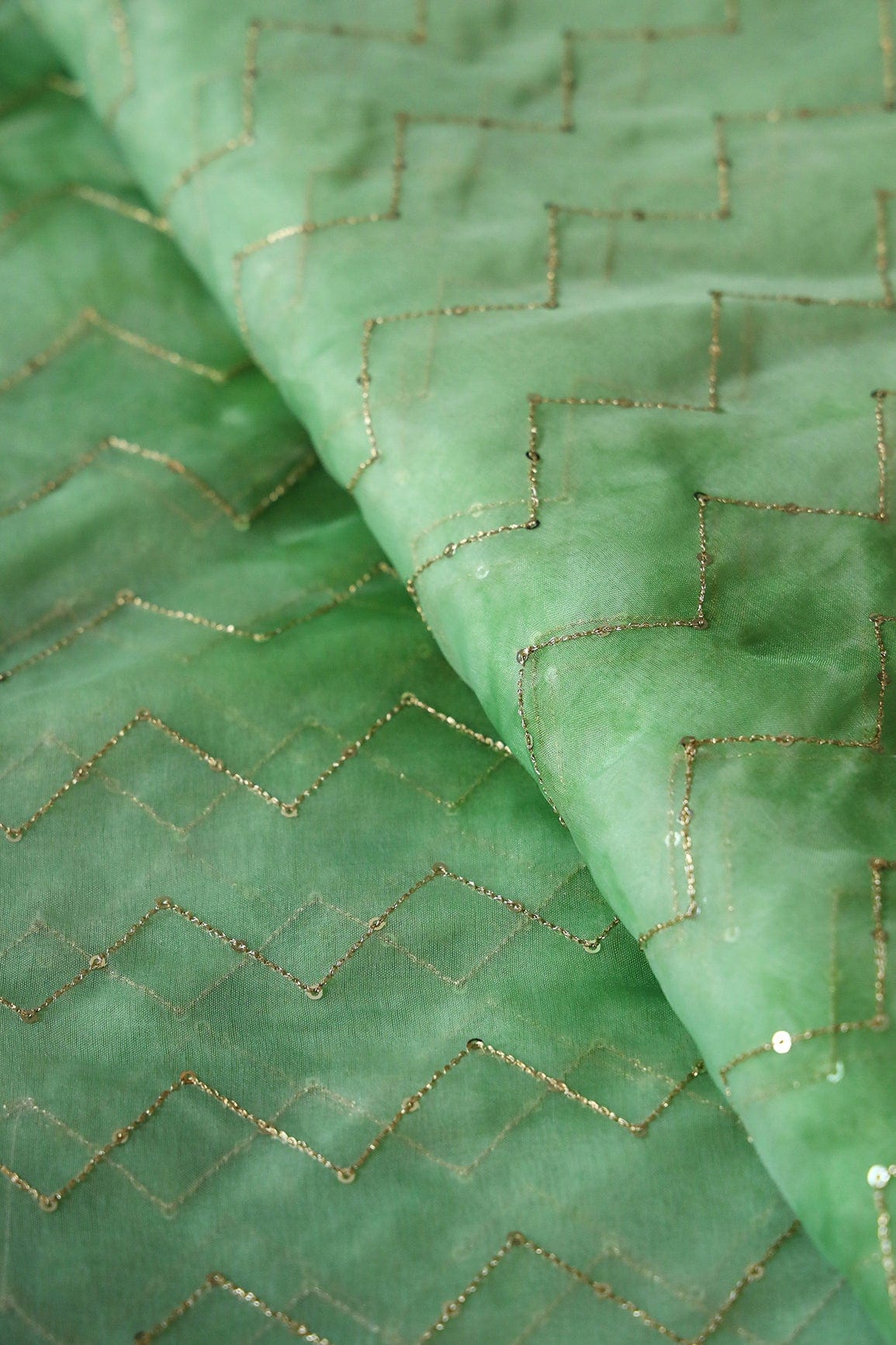 AIzaSyBcstauz-XMPRhEY21AUzeo032pxrXB5Ug - Gold Sequins Chevron Embroidery Work On Tie & Dye Olive Organza Fabric