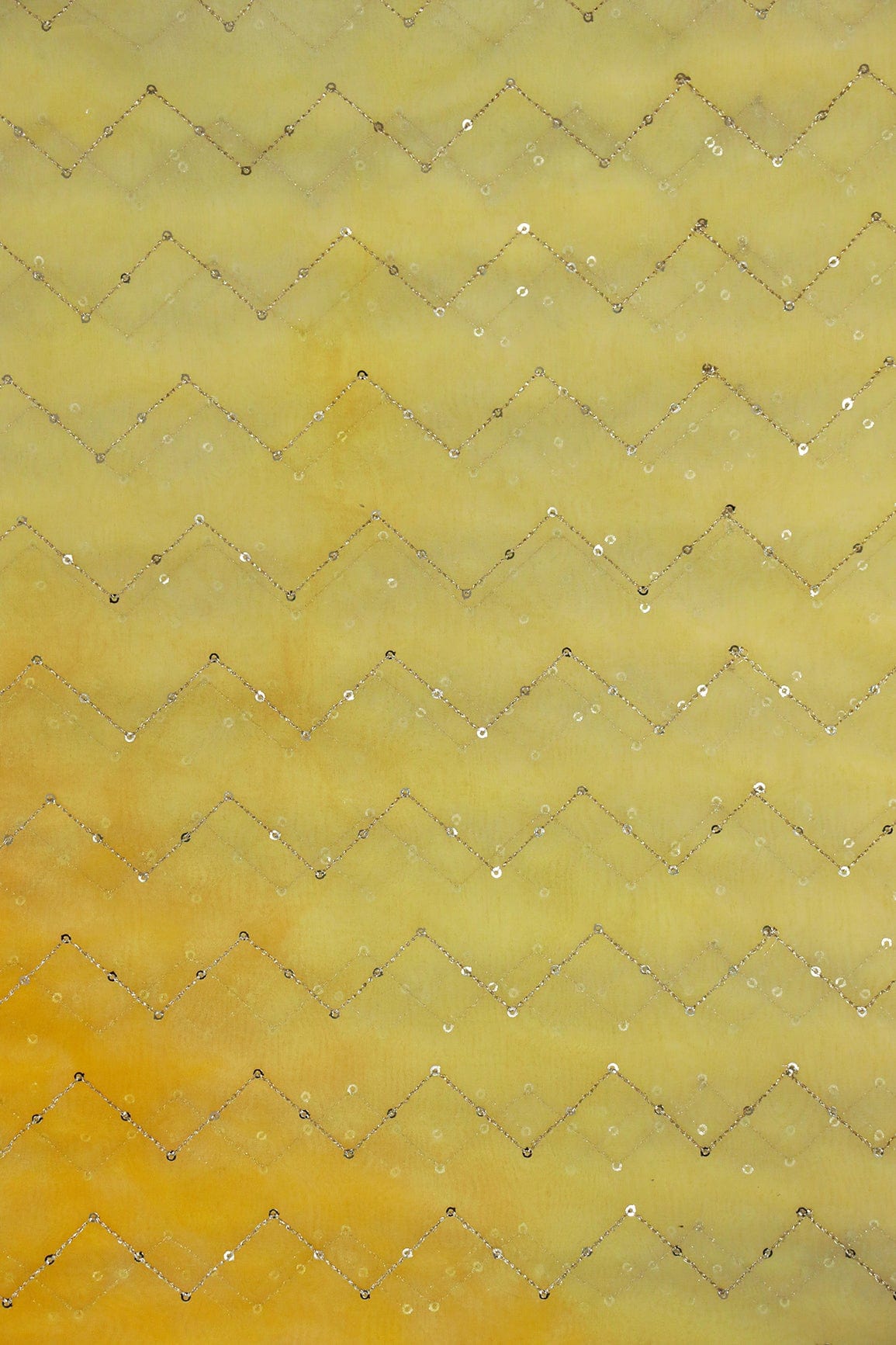 AIzaSyBcstauz-XMPRhEY21AUzeo032pxrXB5Ug - Gold Sequins Chevron Embroidery Work On Tie & Dye Yellow Organza Fabric
