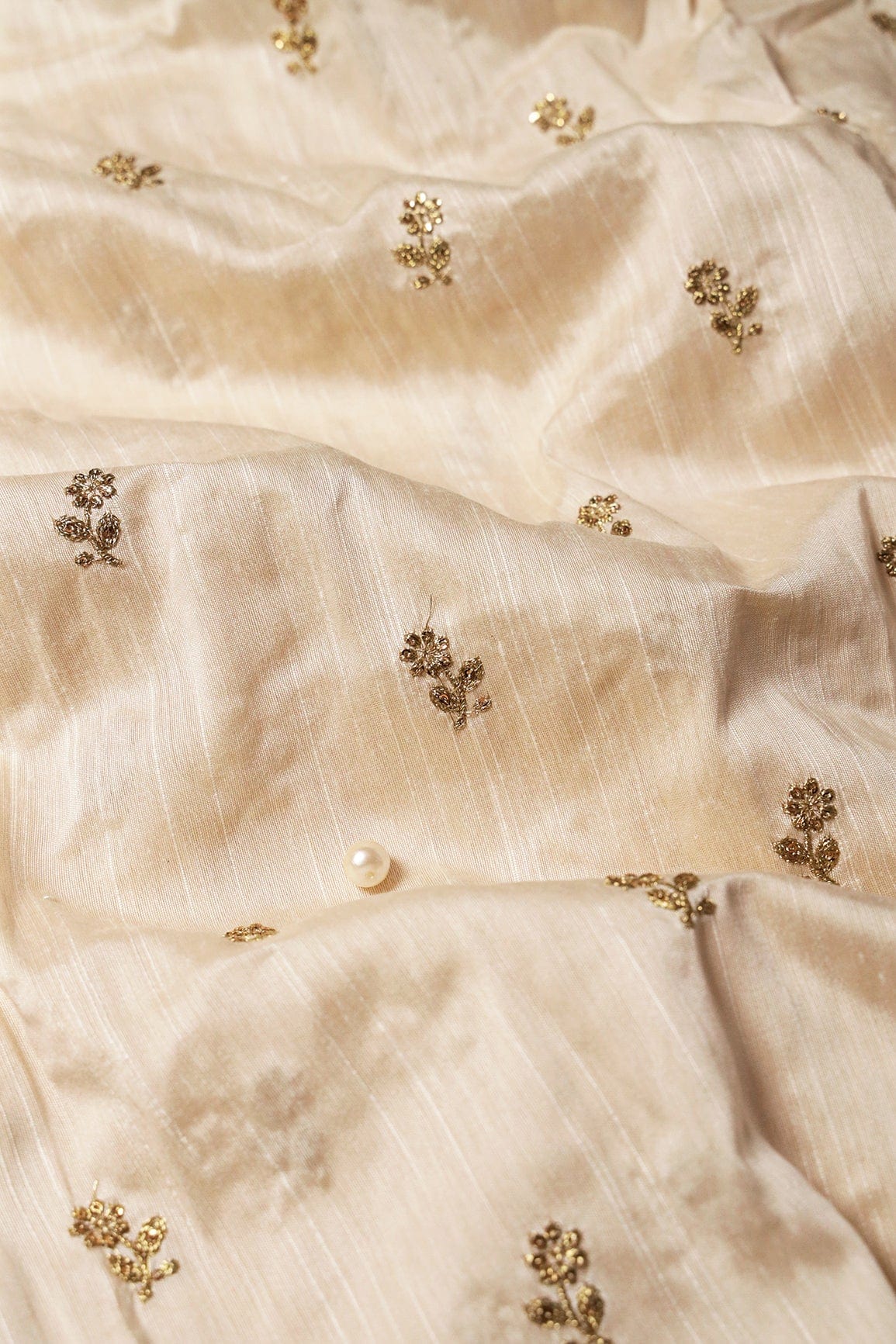 AIzaSyBcstauz-XMPRhEY21AUzeo032pxrXB5Ug - Gold Sequins With Gold Zari Small Floral Motif Embroidery Work On White Raw Silk Fabric