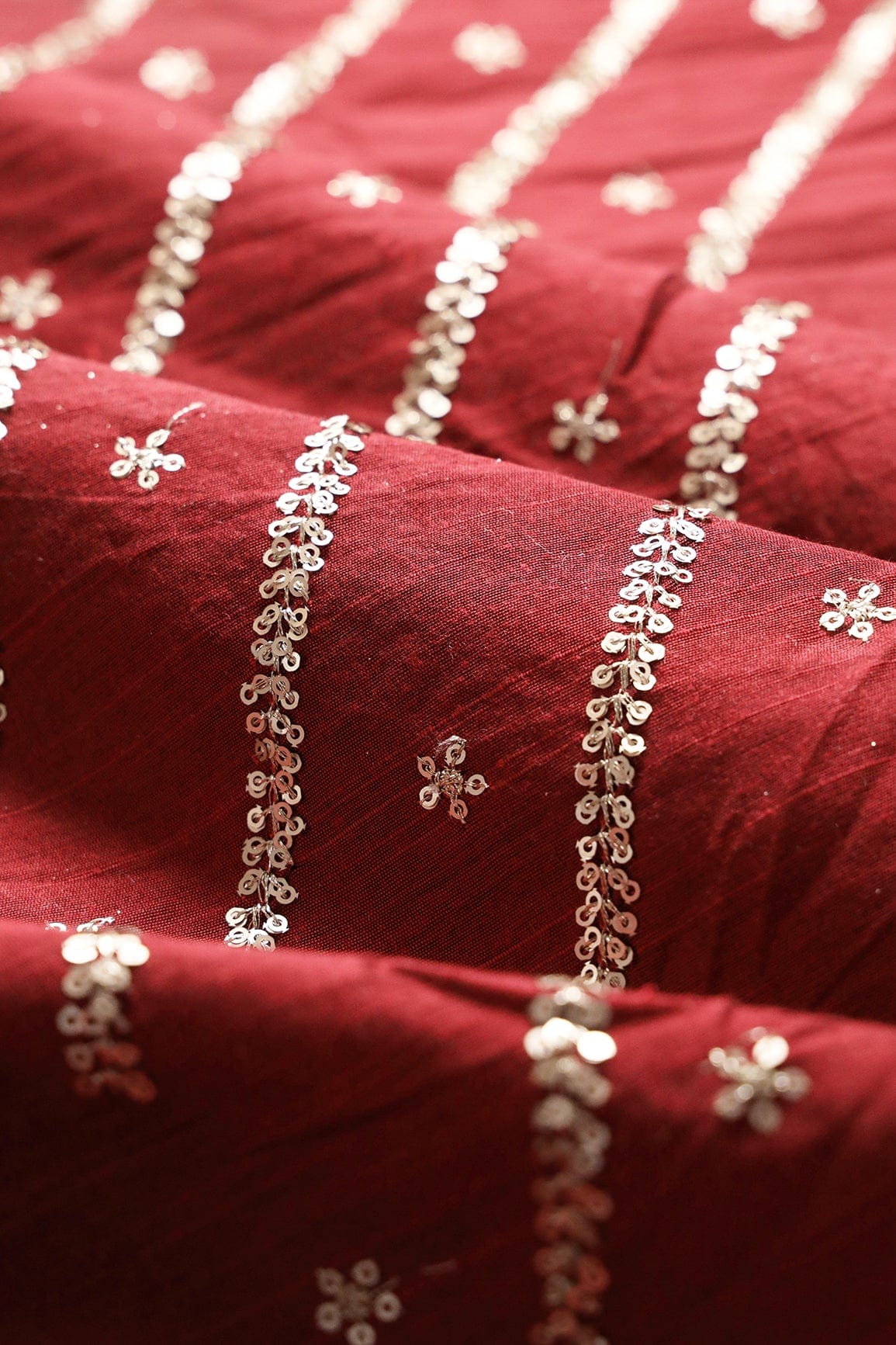 AIzaSyBcstauz-XMPRhEY21AUzeo032pxrXB5Ug - Gold Sequins With Gold Zari Stripes And Small Motif Embroidery Work On Maroon Raw Silk Fabric