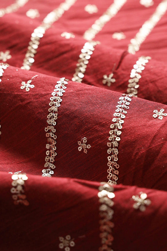 AIzaSyBcstauz-XMPRhEY21AUzeo032pxrXB5Ug - Gold Sequins With Gold Zari Stripes And Small Motif Embroidery Work On Maroon Raw Silk Fabric