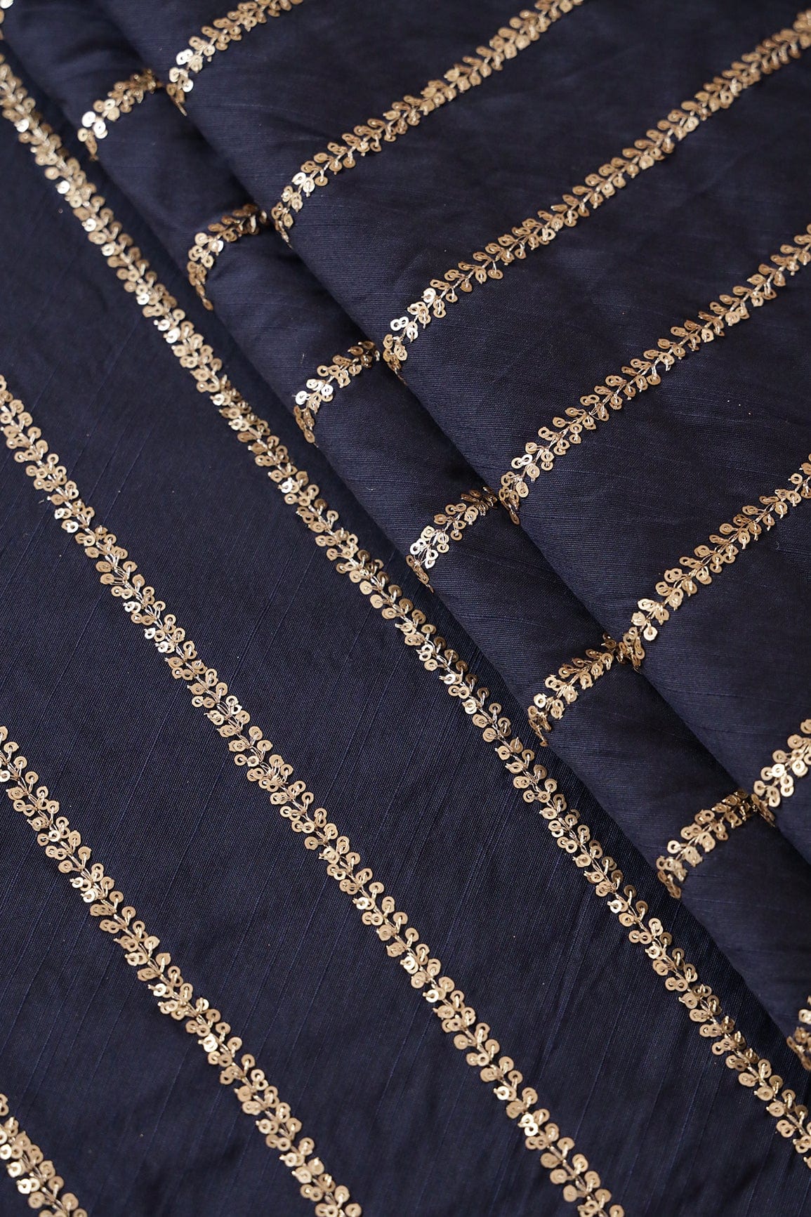 AIzaSyBcstauz-XMPRhEY21AUzeo032pxrXB5Ug - Gold Sequins With Gold Zari Stripes Embroidery Work On Navy Blue Raw Silk Fabric