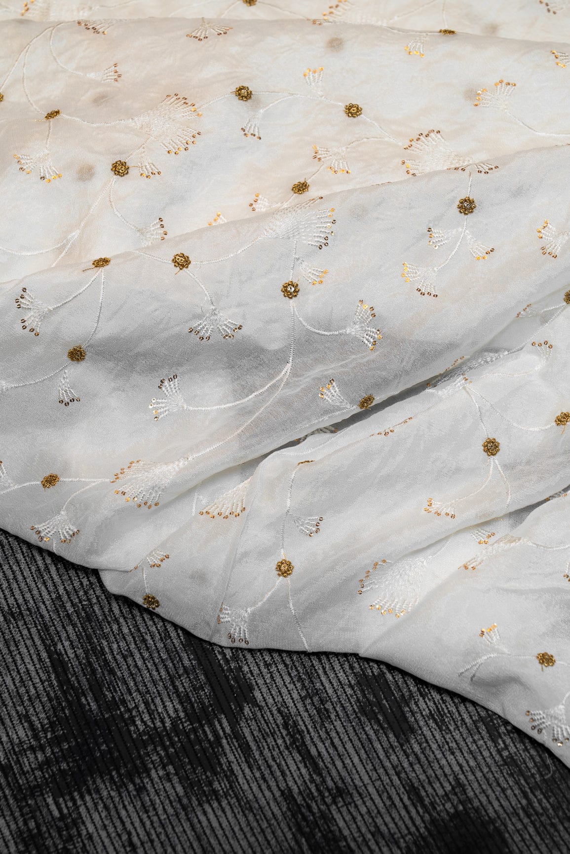 AIzaSyBcstauz-XMPRhEY21AUzeo032pxrXB5Ug - Gold Sequins With White Thread Floral Embroidery On Dyeable Natural Crepe