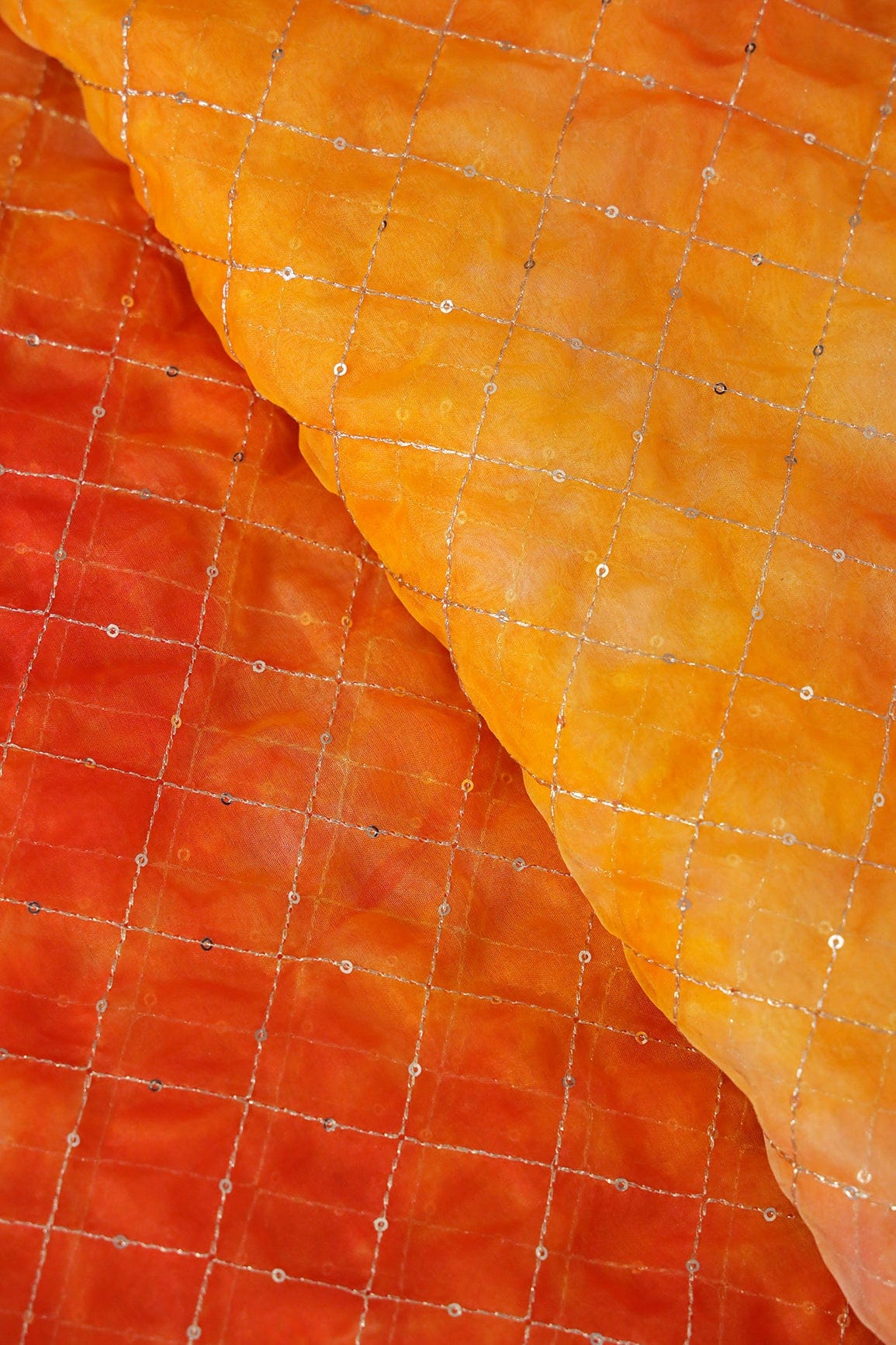 AIzaSyBcstauz-XMPRhEY21AUzeo032pxrXB5Ug - Gold Zari With Gold Sequins Checks Embroidery Work On Tie & Dye Orange And Yellow Organza Fabric