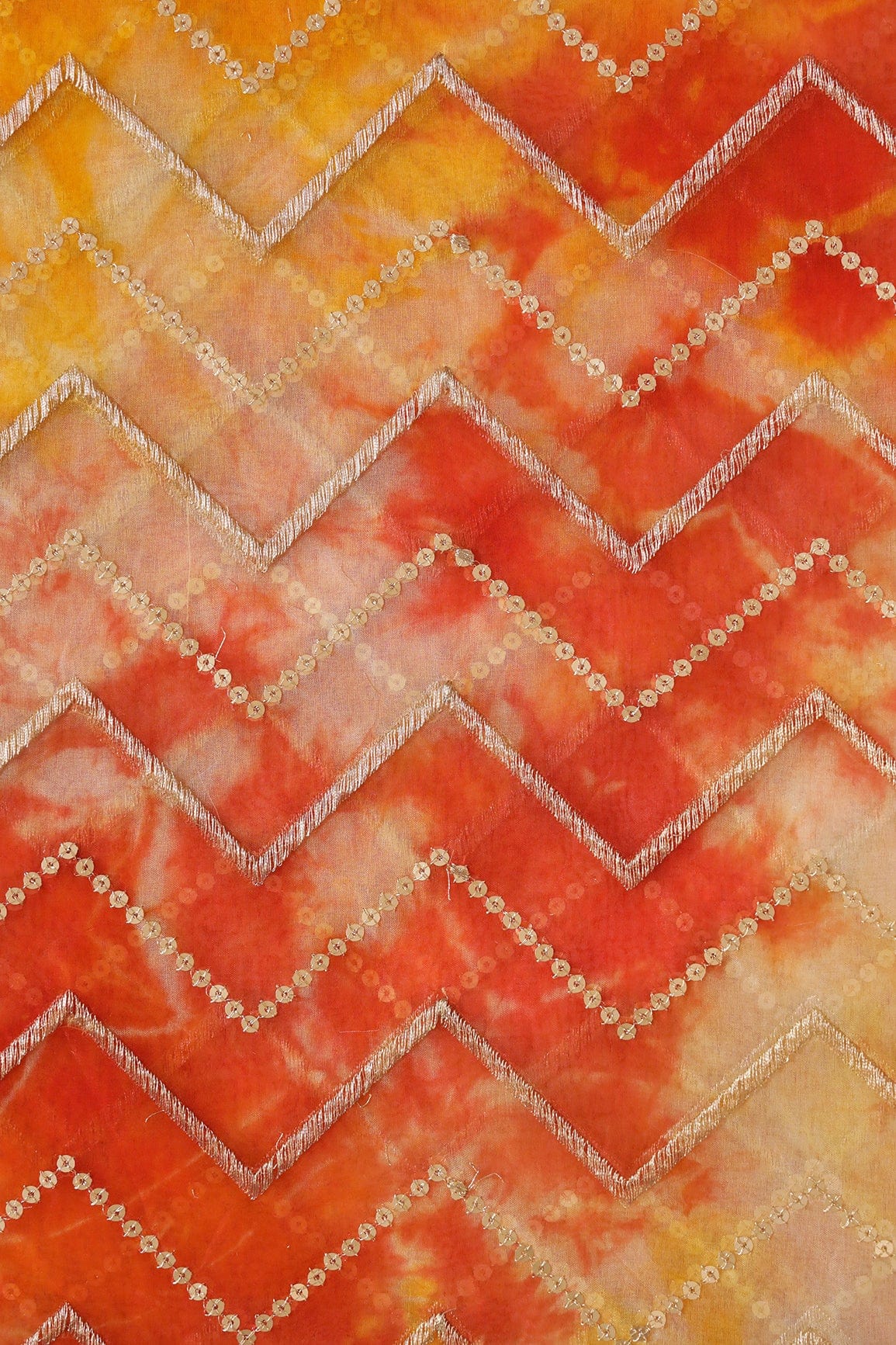 AIzaSyBcstauz-XMPRhEY21AUzeo032pxrXB5Ug - Gold Zari With Gold Sequins Chevron Embroidery Work On Tie & Dye Dark Orange And Yellow Organza Fabric