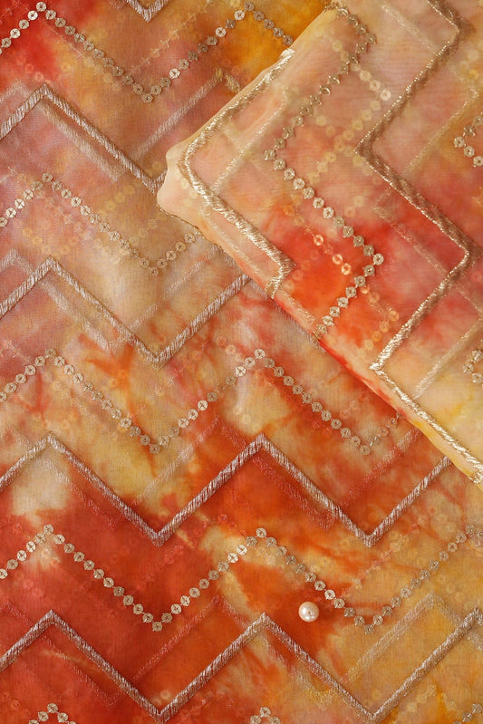 AIzaSyBcstauz-XMPRhEY21AUzeo032pxrXB5Ug - Gold Zari With Gold Sequins Chevron Embroidery Work On Tie & Dye Dark Orange And Yellow Organza Fabric