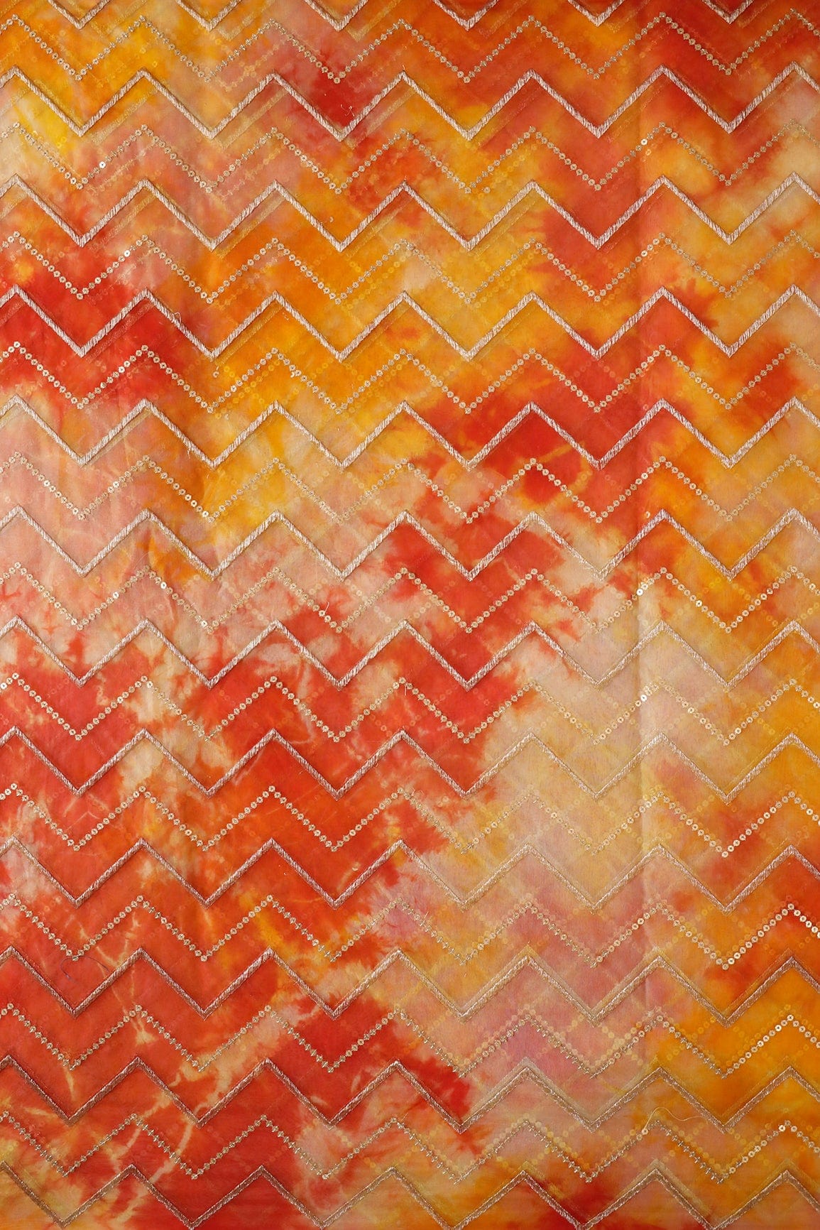 AIzaSyBcstauz-XMPRhEY21AUzeo032pxrXB5Ug - Gold Zari With Gold Sequins Chevron Embroidery Work On Tie & Dye Dark Orange And Yellow Organza Fabric