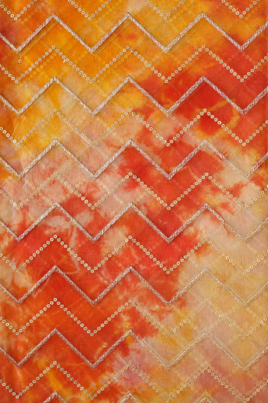 AIzaSyBcstauz-XMPRhEY21AUzeo032pxrXB5Ug - Gold Zari With Gold Sequins Chevron Embroidery Work On Tie & Dye Dark Orange And Yellow Organza Fabric