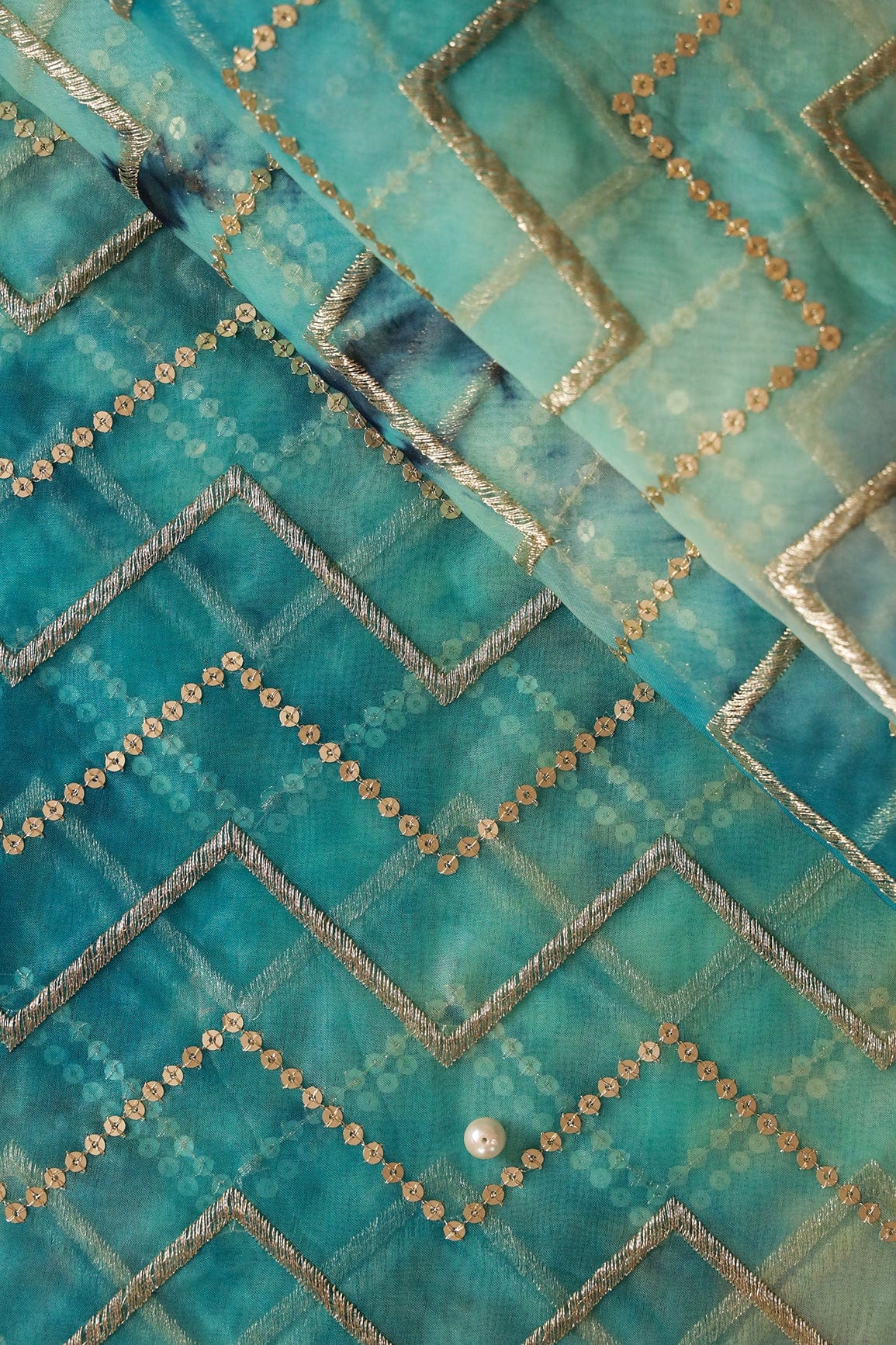 AIzaSyBcstauz-XMPRhEY21AUzeo032pxrXB5Ug - Gold Zari With Gold Sequins Chevron Embroidery Work On Tie & Dye Turquoise And Light Blue Organza Fabric