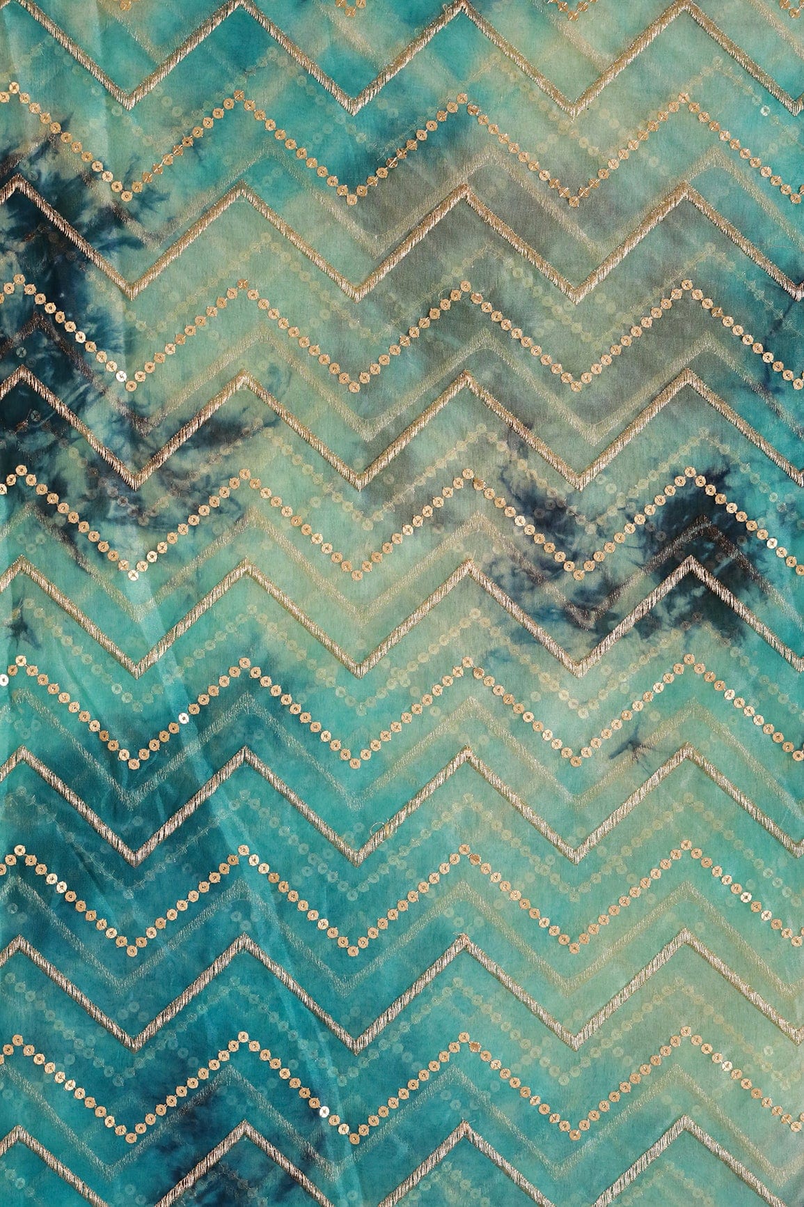 AIzaSyBcstauz-XMPRhEY21AUzeo032pxrXB5Ug - Gold Zari With Gold Sequins Chevron Embroidery Work On Tie & Dye Turquoise And Light Blue Organza Fabric