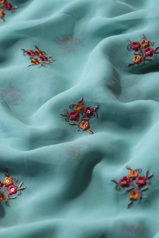Orange And Dark Pink Thread With Sequins Floral Embroidery Work On Teal Georgette Fabric